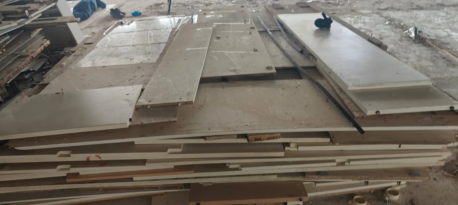 Before and after comparison of an office furniture dismantling service in Electronic City, showing workstation clusters cleared into stacked panels